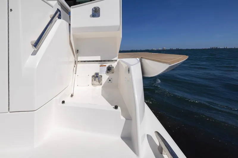 Slide: The Image of Tiara Yachts EX 54, 2025 model, featuring sleek deck design against ocean backdrop. - 9