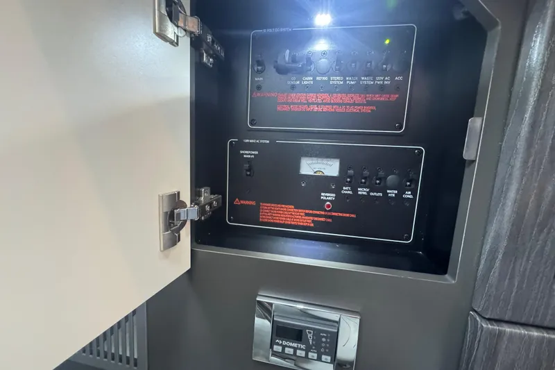 Slide: The Image of Control panel inside 2020 Formula 330 Crossover Bowrider, featuring various switches and indicators. - 10