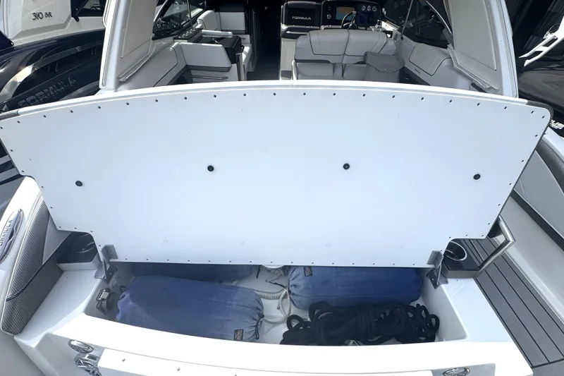 Slide: The Image of 2020 Formula 330 Crossover Bowrider interior with white seating and stainless steel accents. - 14