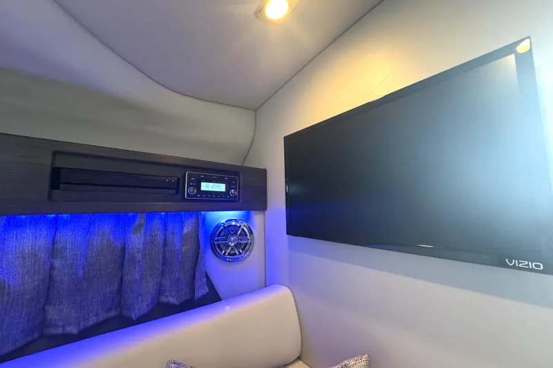 Slide: The Image of 2020 Formula 330 Crossover Bowrider interior with seating and table, parked near water. - 16