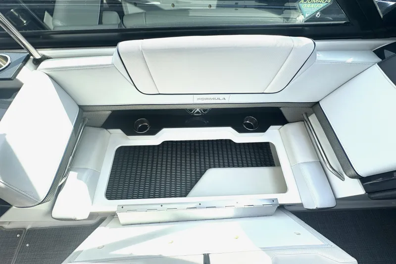 Slide: The Image of 2020 Formula 330 Crossover Bowrider storage compartment with control panel and fire extinguisher. - 30