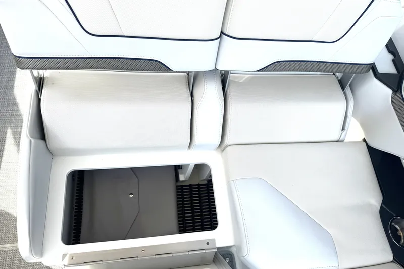 Slide: The Image of 2020 Formula 330 Crossover Bowrider seating with storage compartment, featuring white upholstery. - 34