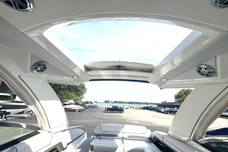 Slide: The Image of Interior view of 2020 Formula 330 Crossover Bowrider with open sunroof and seating. - 4
