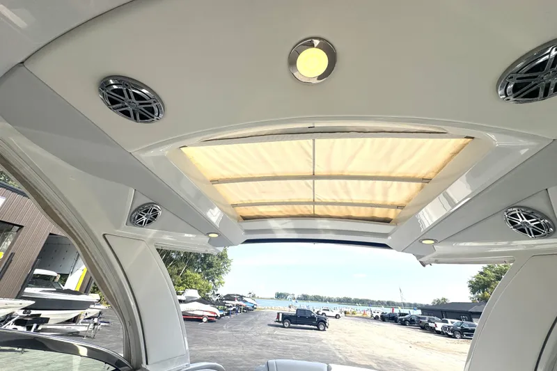 Slide: The Image of 2020 Formula 330 Crossover Bowrider interior with sunroof and speakers, dockside view. - 6