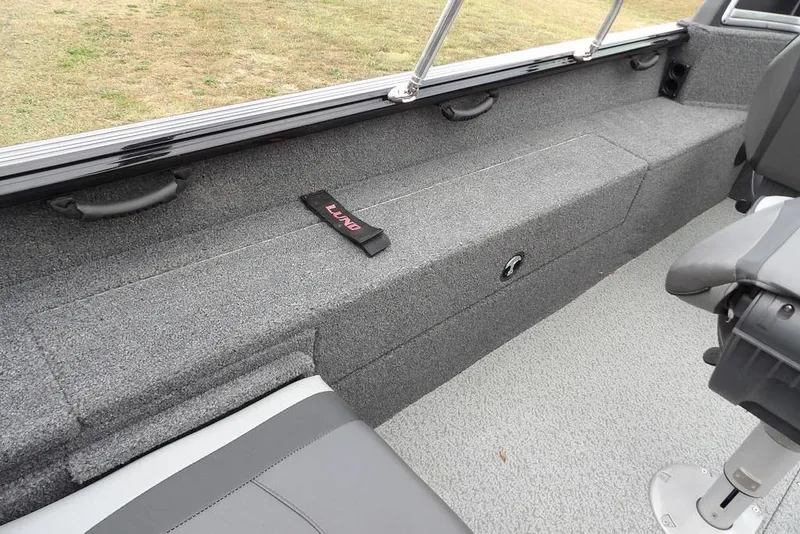 Slide: The Image of 2022 Lund 1875 Impact Sport boat interior with gray seating and storage. - 10