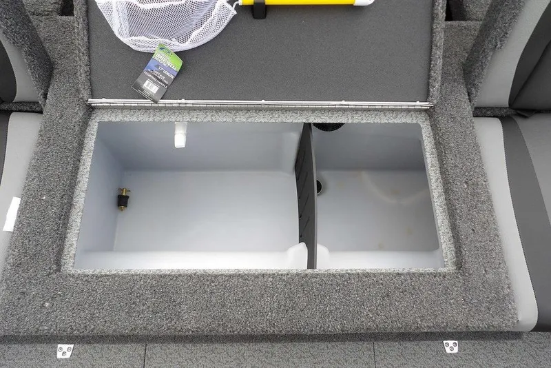Slide: The Image of 2022 Lund 1875 Impact Sport boat storage compartment with gray carpet and accessories. - 11