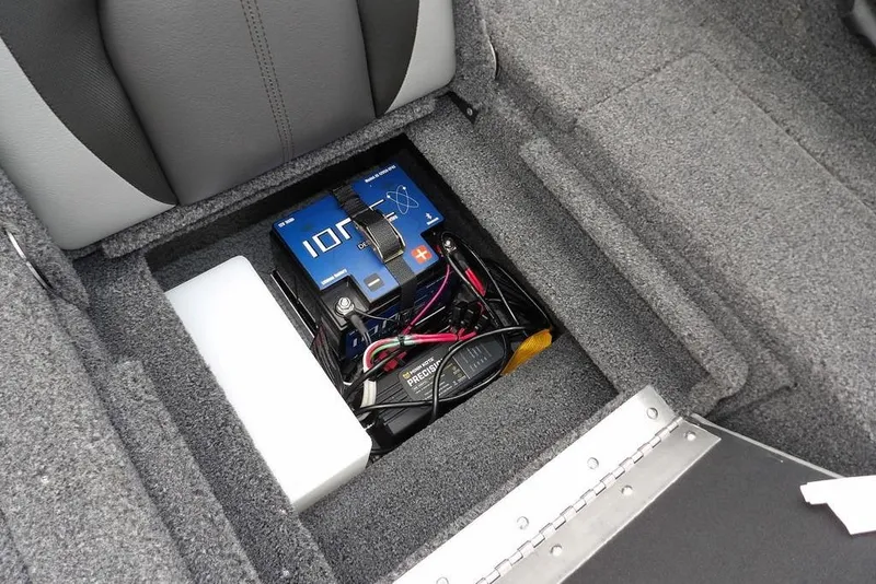 Slide: The Image of 2022 Lund 1875 Impact Sport battery compartment with IONIC deep cycle battery and wiring. - 12