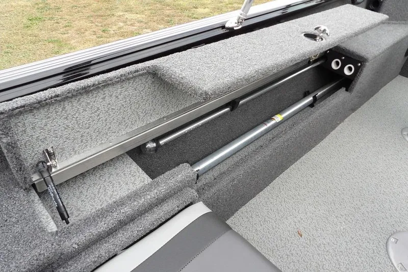 Slide: The Image of 2022 Lund 1875 Impact Sport boat interior storage compartment with gray carpeting. - 15