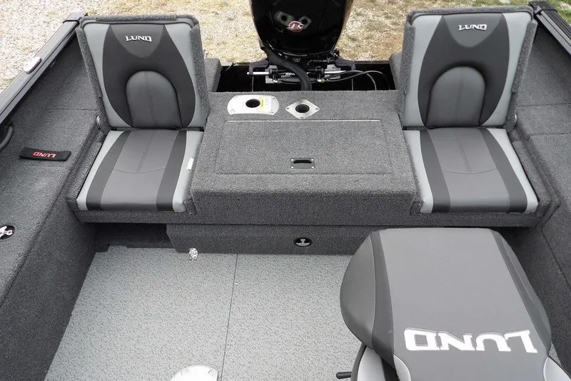 Slide: The Image of 2022 Lund 1875 Impact Sport boat interior with gray seating and storage compartments. - 18