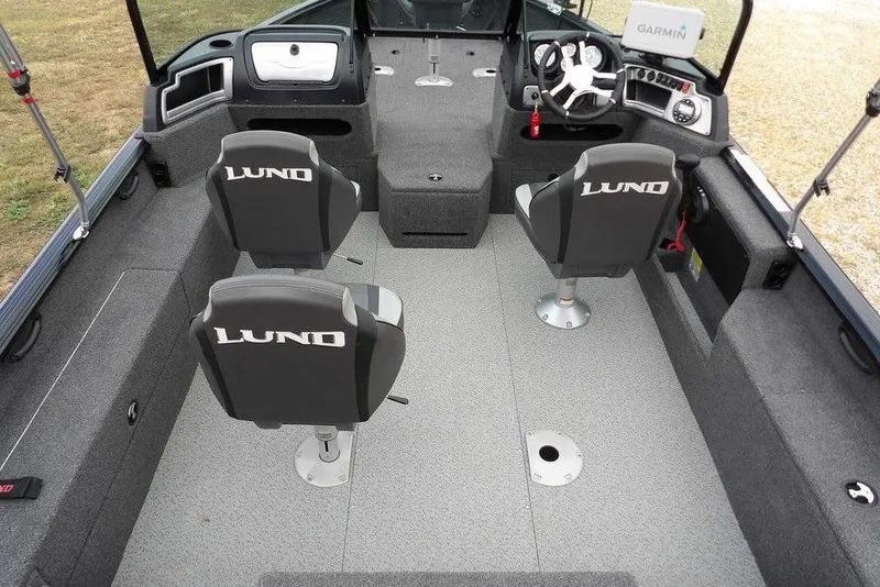 Slide: The Image of 2022 Lund 1875 Impact Sport boat interior with two seats and steering console. - 19