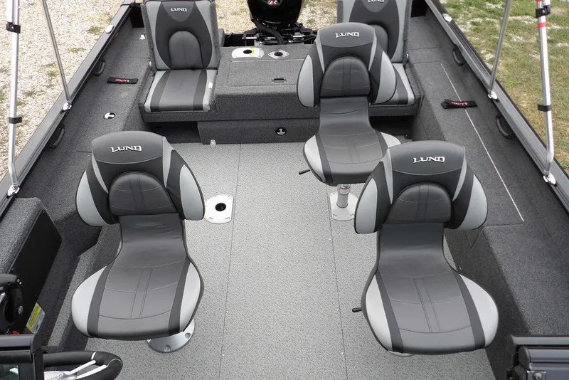 Slide: The Image of 2022 Lund 1875 Impact Sport boat interior with four gray seats and spacious layout. - 25