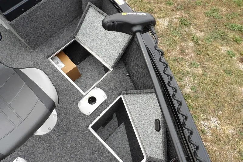 Slide: The Image of 2022 Lund 1875 Impact Sport boat interior with storage compartments and Minn Kota trolling motor. - 27