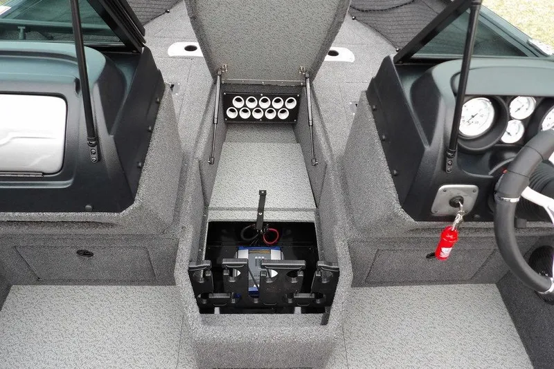 Slide: The Image of 2022 Lund 1875 Impact Sport boat interior with storage compartments and control panel. - 28