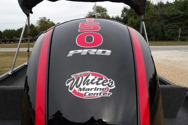 Slide: The Image of Outboard motor on 2022 Lund 1875 Impact Sport, featuring red stripes and marine center logo. - 36