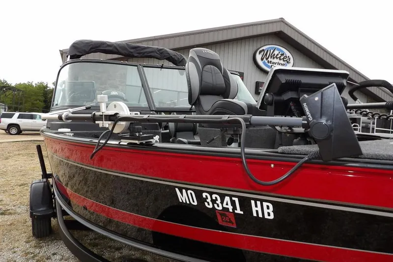 Slide: The Image of 2022 Lund 1875 Impact Sport boat in red, parked at White's Marine dealership. - 37