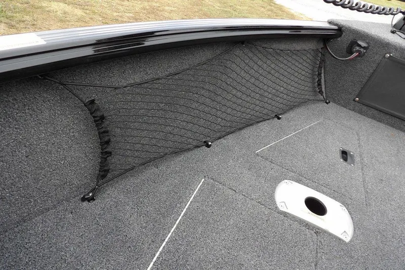 Slide: The Image of 2022 Lund 1875 Impact Sport boat interior with storage netting and carpeted flooring. - 38