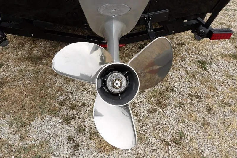 Slide: The Image of 2022 Lund 1875 Impact Sport boat propeller on gravel surface. - 43