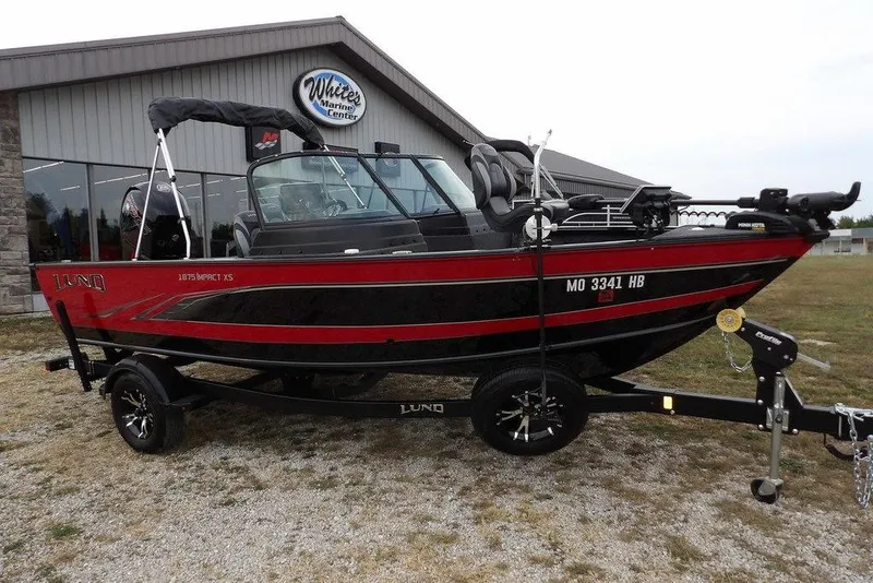 Slide: The Image of 2022 Lund 1875 Impact Sport boat on trailer outside marine center. - 6