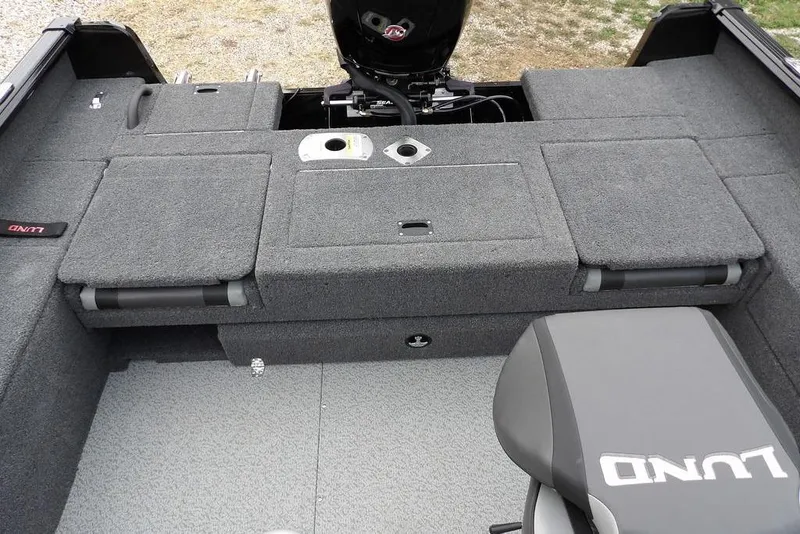 Slide: The Image of 2022 Lund 1875 Impact Sport boat interior with gray carpet and seating. - 9