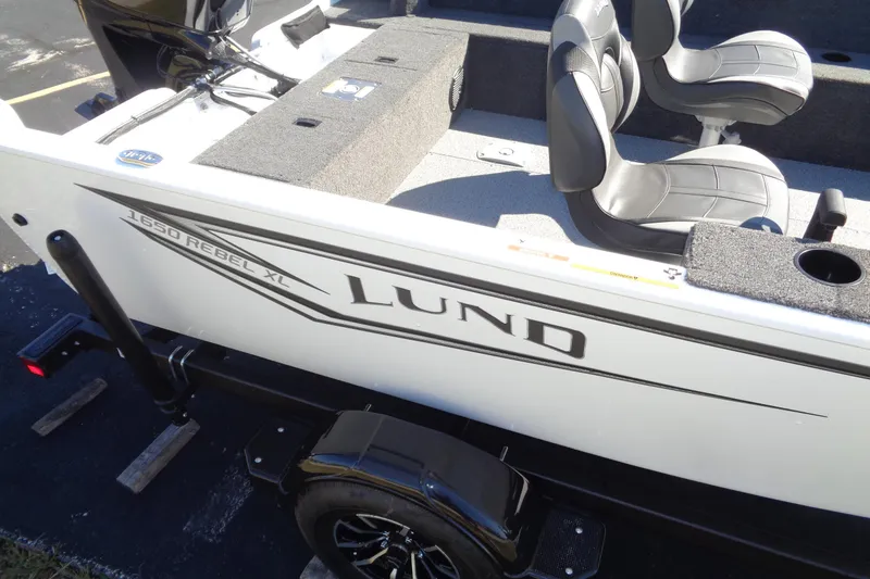 Slide: The Image of 2026 Lund 1650 Rebel XL SS boat with seating and storage, on a trailer. - 10