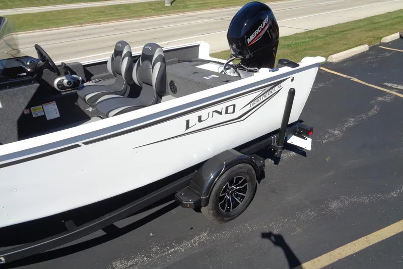 Slide: The Image of 2026 Lund 1650 Rebel XL SS boat on trailer, featuring Mercury outboard motor. - 2