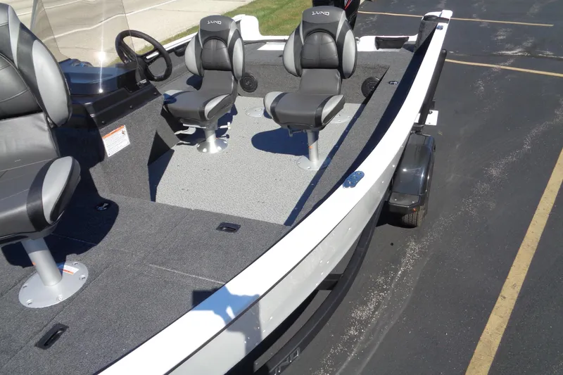 Slide: The Image of 2026 Lund 1650 Rebel XL SS boat interior with seating and steering console. - 4