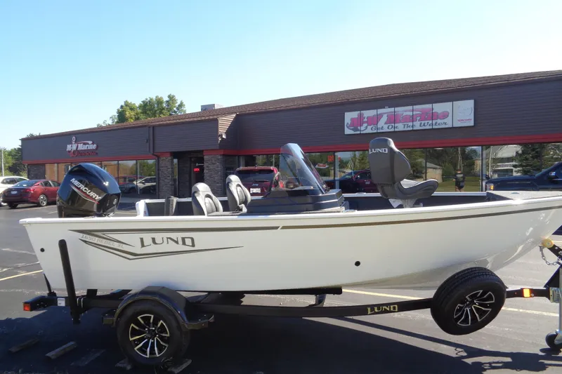 Slide: The Image of 2026 Lund 1650 Rebel XL SS boat on trailer outside dealership. - 9