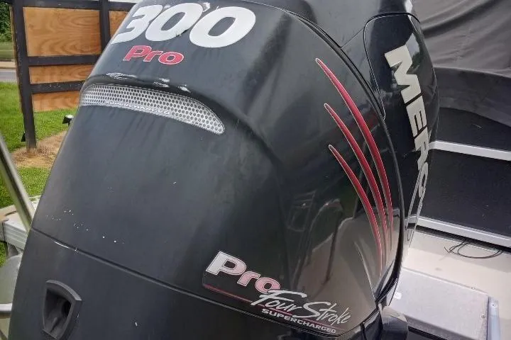 Slide: The Image of Outboard motor on a 2013 Premier 290 Grand Isle boat, featuring "300 Pro" branding. - 2