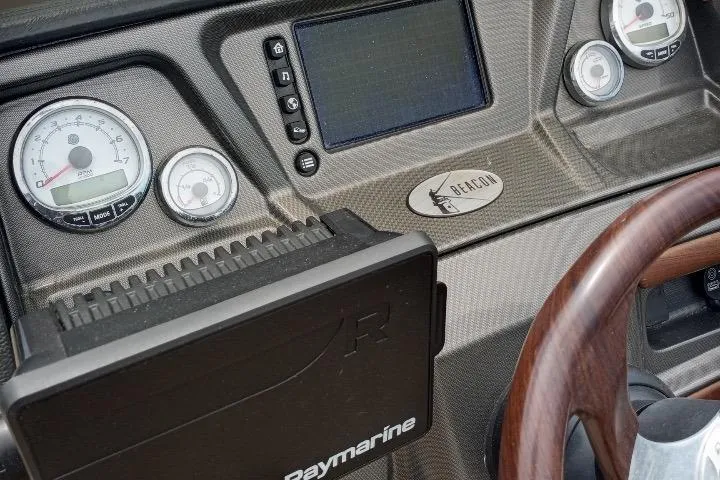 Slide: The Image of Dashboard of 2013 Premier 290 Grand Isle boat with gauges and Raymarine equipment. - 4