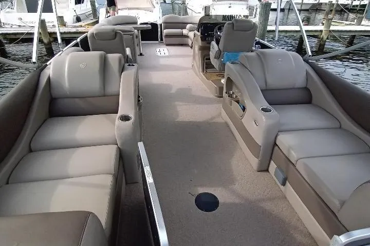 Slide: The Image of 2013 Premier 290 Grand Isle pontoon boat with spacious seating and modern interior at a marina. - 6