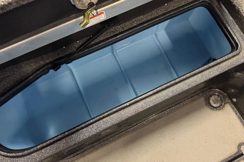 Slide: The Image of Open storage compartment in 2022 Nitro ZV21 Pro boat, featuring a blue interior. - 11