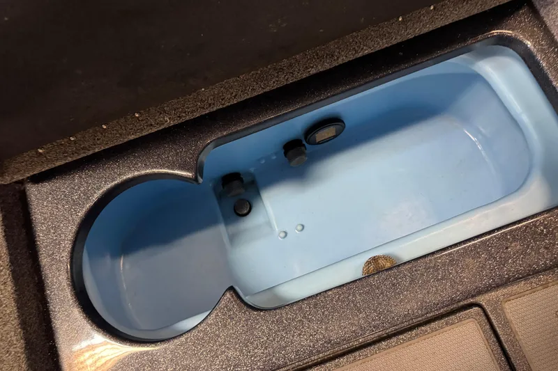 Slide: The Image of Livewell compartment in 2022 Nitro ZV21 Pro boat, featuring a blue interior. - 12