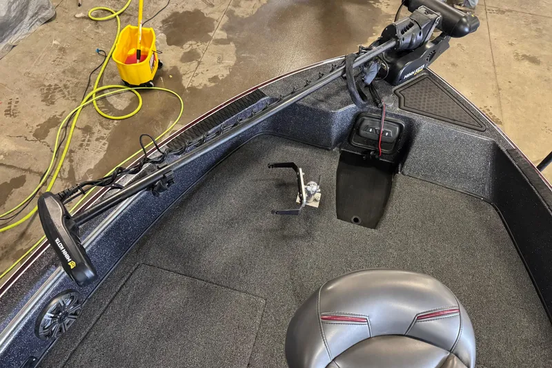 Slide: The Image of 2022 Nitro ZV21 Pro boat interior with Minn Kota trolling motor and cleaning supplies. - 15