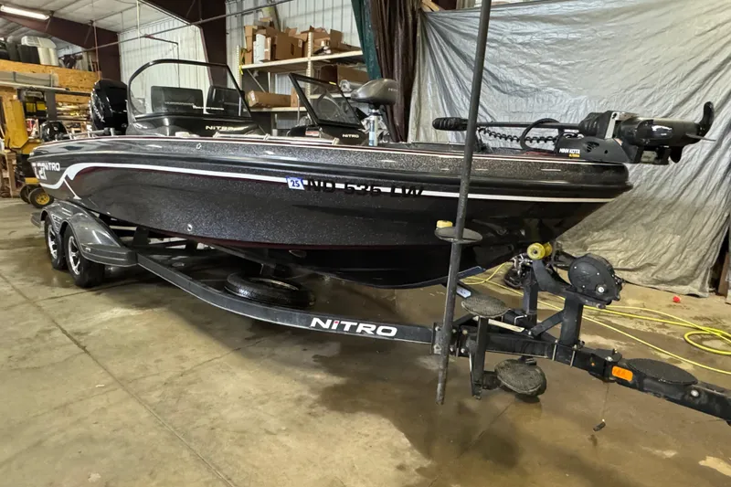 Slide: The Image of 2022 Nitro ZV21 Pro boat on trailer in a warehouse setting. - 2