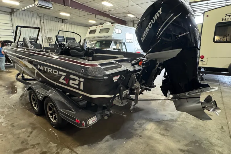 Slide: The Image of 2022 Nitro ZV21 Pro boat with Mercury Verado engine in a garage setting. - 4