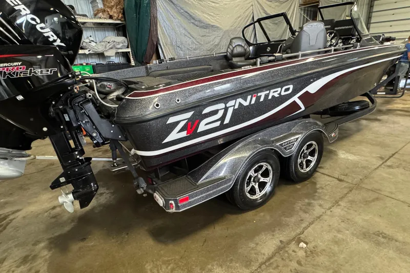 Slide: The Image of 2022 Nitro ZV21 Pro boat on trailer in garage setting. - 5