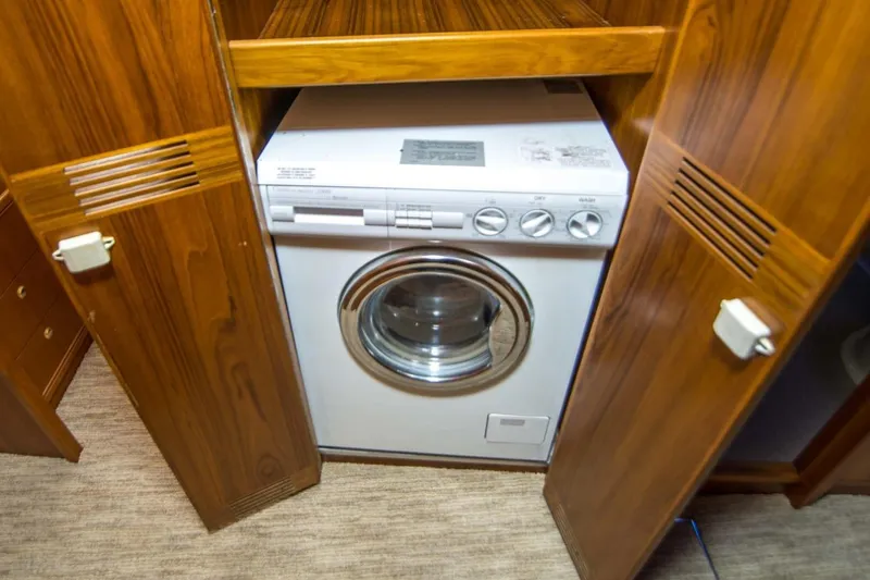Slide: The Image of Washing machine in wooden cabinet on 2000 Riviera 48 Enclosed Flybridge yacht. - 13