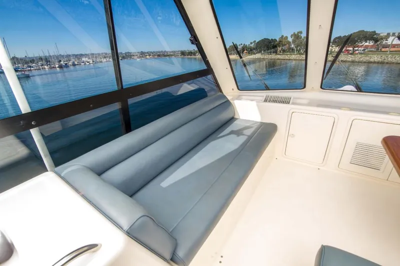 Slide: The Image of Interior of 2000 Riviera 48 Enclosed Flybridge with scenic marina view. - 18