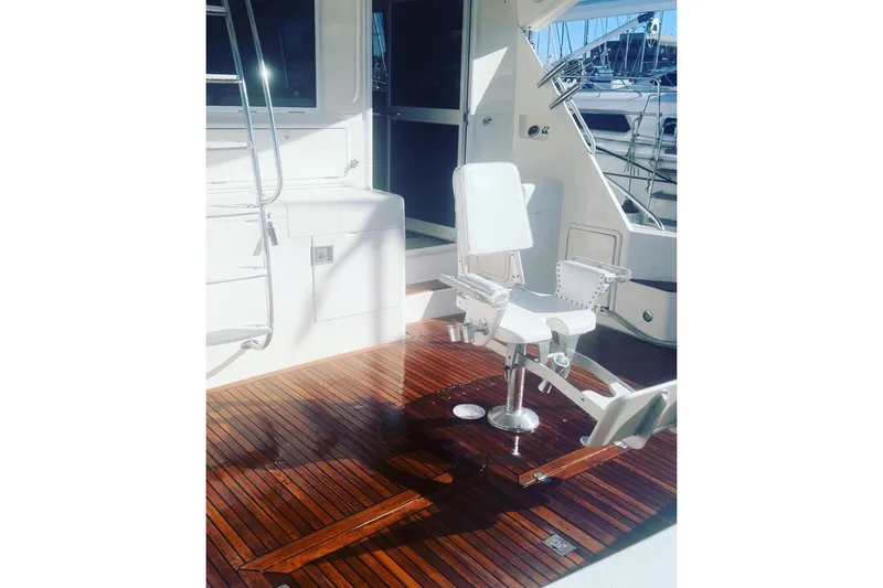 Slide: The Image of 2000 Riviera 48 Enclosed Flybridge with teak deck and fishing chair. - 22