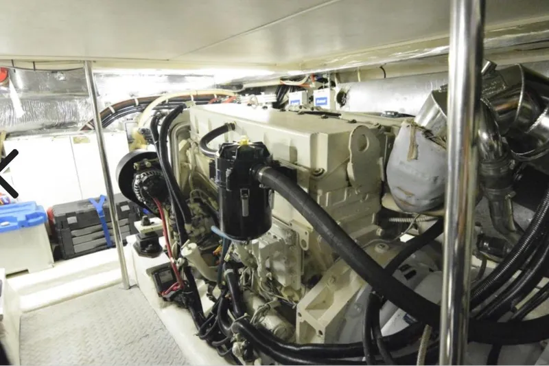 Slide: The Image of Engine room of 2000 Riviera 48 Enclosed Flybridge with visible machinery and equipment. - 24