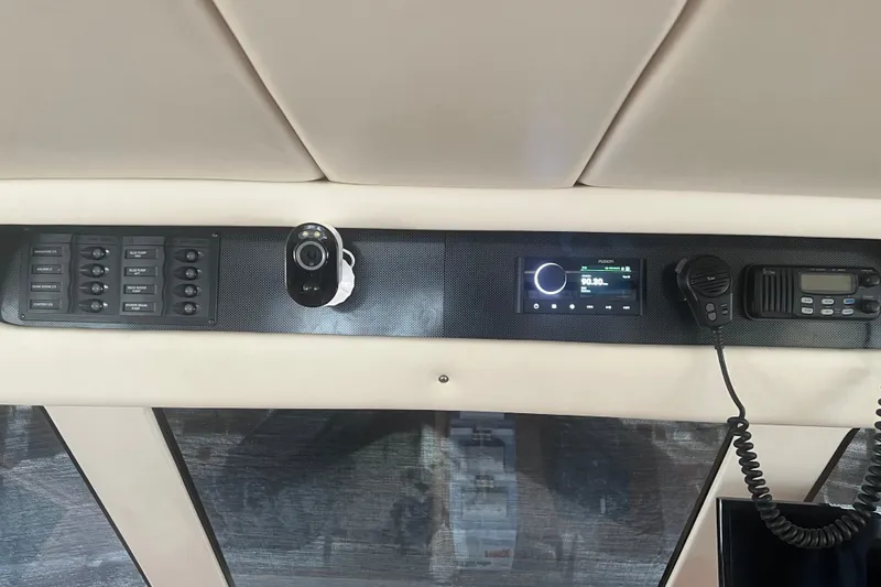 Slide: The Image of Control panel of 2000 Riviera 48 Enclosed Flybridge with radio and communication devices. - 3