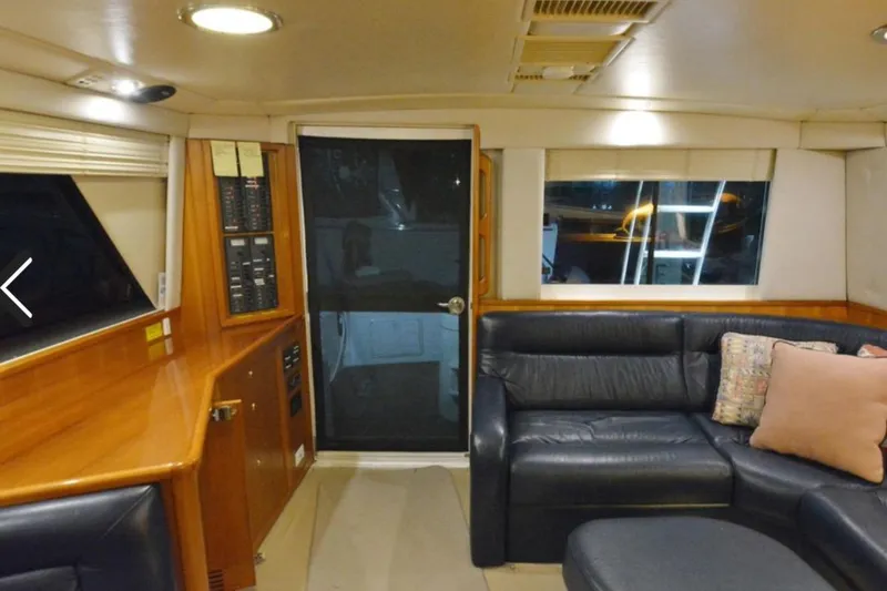 Slide: The Image of Interior of 2000 Riviera 48 Enclosed Flybridge with leather seating and wood accents. - 5
