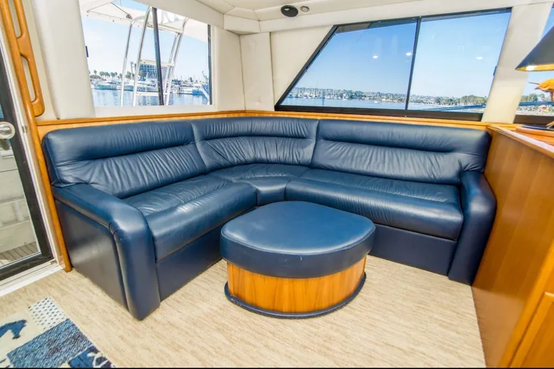 Slide: The Image of Luxurious interior of 2000 Riviera 48 Enclosed Flybridge with blue leather seating. - 6
