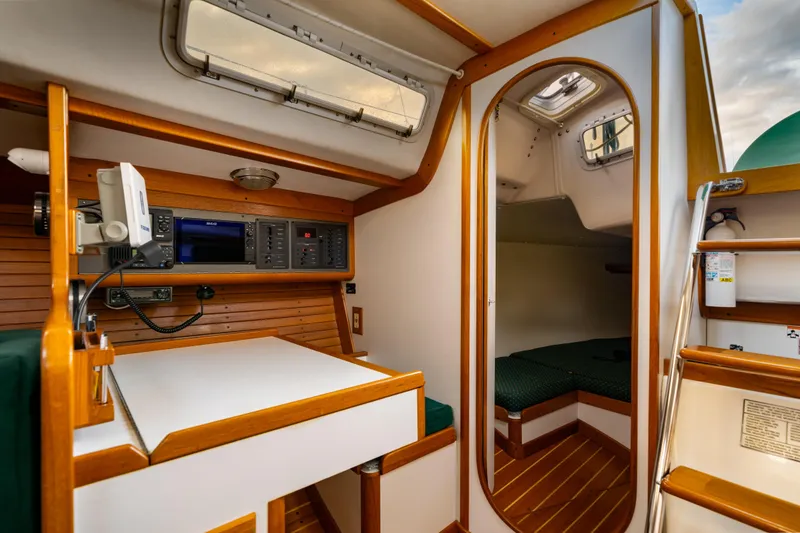 Slide: The Image of Interior of 2000 J Boats J/120 sailboat with navigation station and cozy cabin. - 11