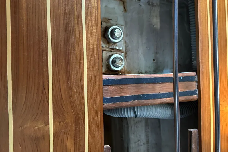 Slide: The Image of Interior view of a 2000 J Boats J/120 sailboat, showcasing wooden paneling and structural details. - 22