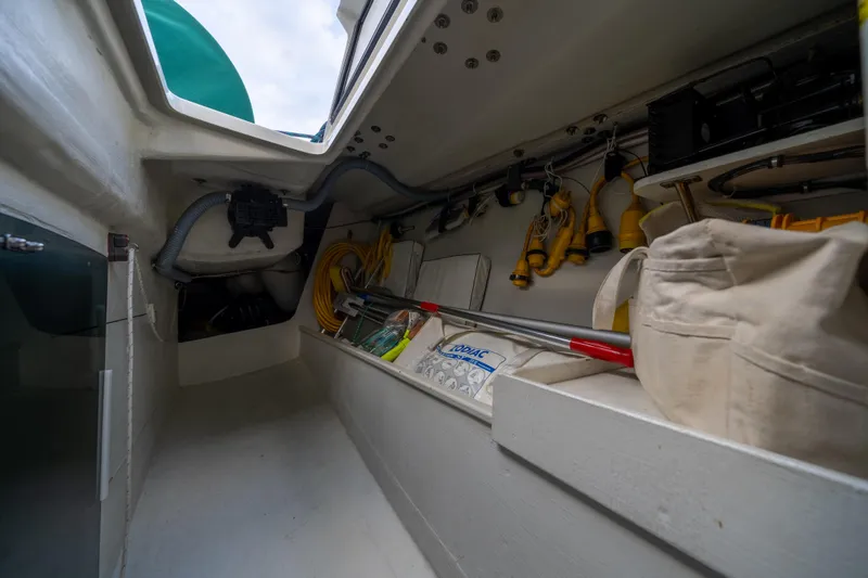 Slide: The Image of Interior storage area of a 2000 J Boats J/120 sailboat, featuring equipment and supplies. - 26