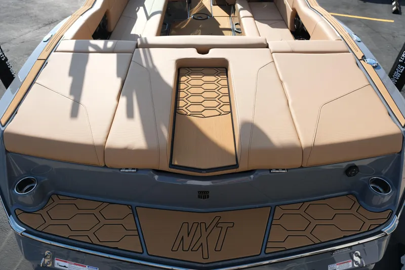 Slide: The Image of 2026 MasterCraft NXT24 boat with tan upholstery and hexagonal design accents. - 10