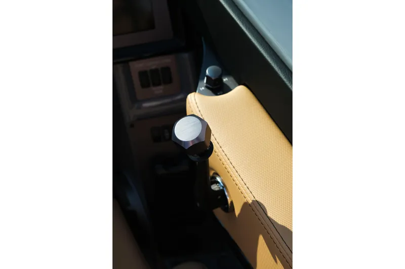 Slide: The Image of Close-up of 2026 MasterCraft NXT24 boat interior with beige upholstery and control knob. - 15