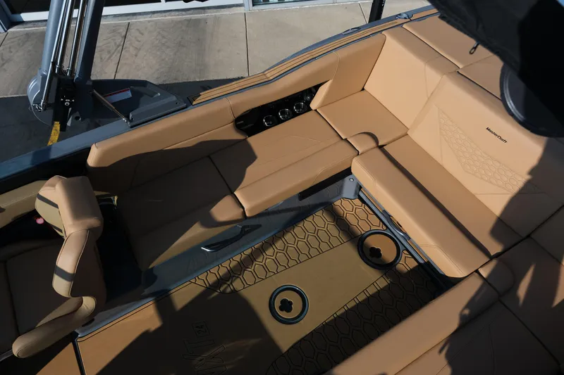 Slide: The Image of 2026 MasterCraft NXT24 boat interior with tan seating and modern design. - 17