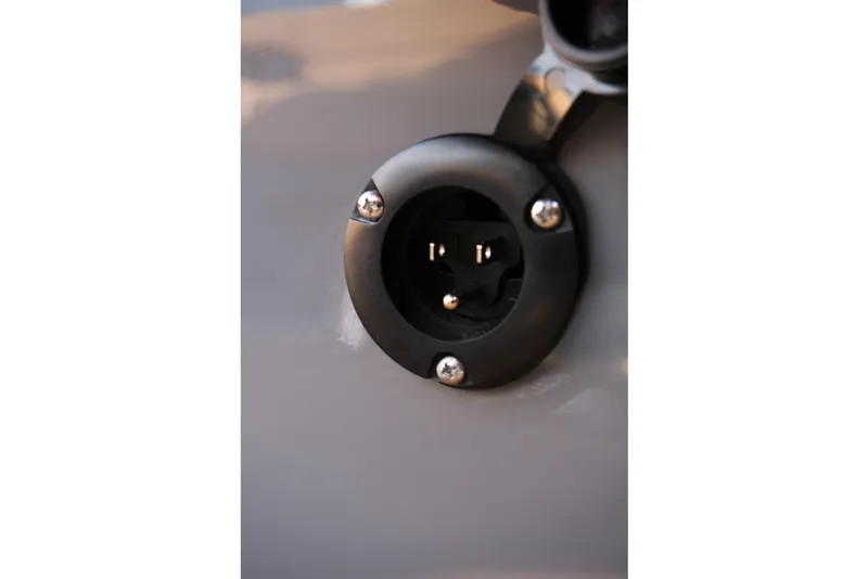 Slide: The Image of Close-up of a 2026 MasterCraft NXT24 boat's electrical socket detail. - 19